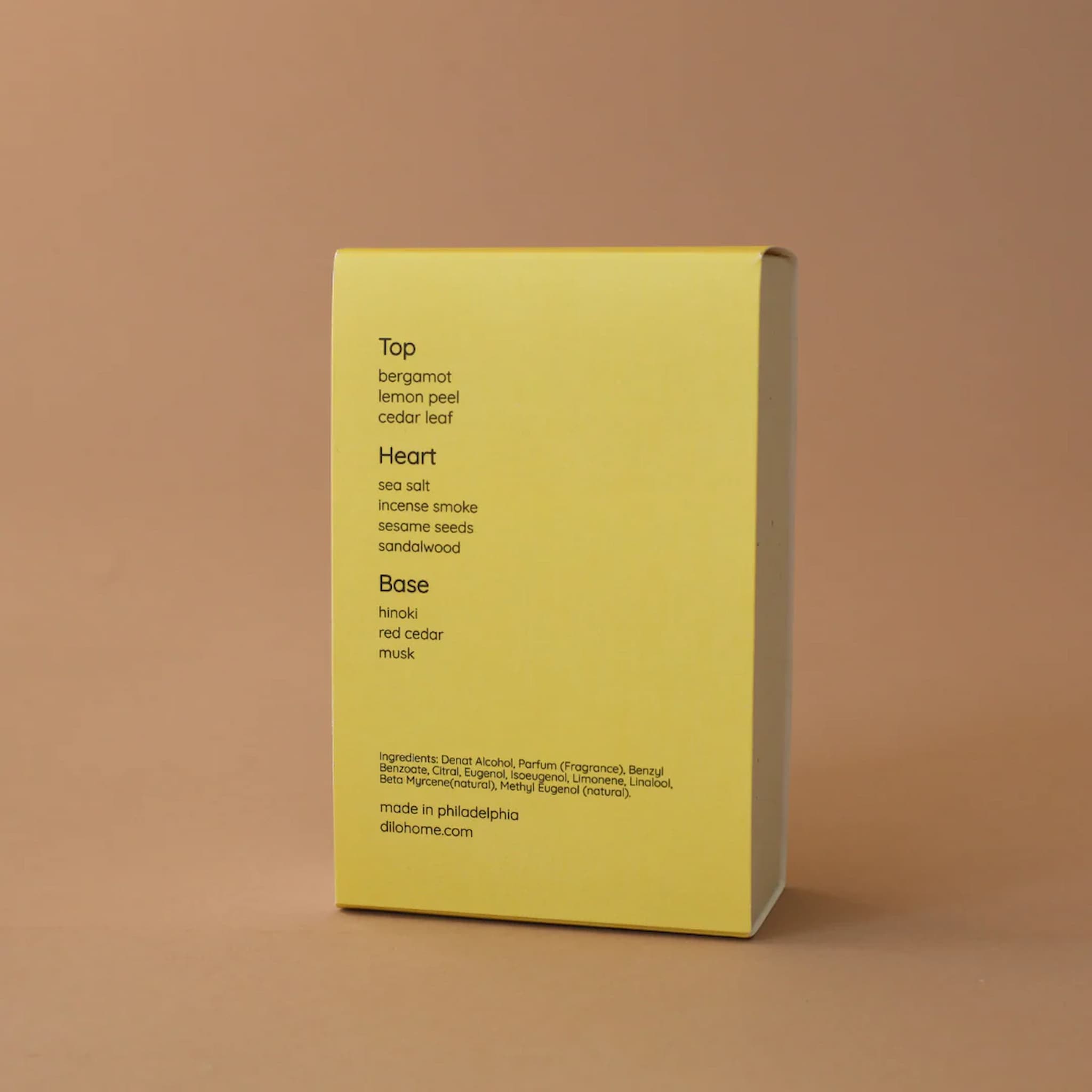 Yellow box for Hinoki Sesame perfume with black text on a brown background