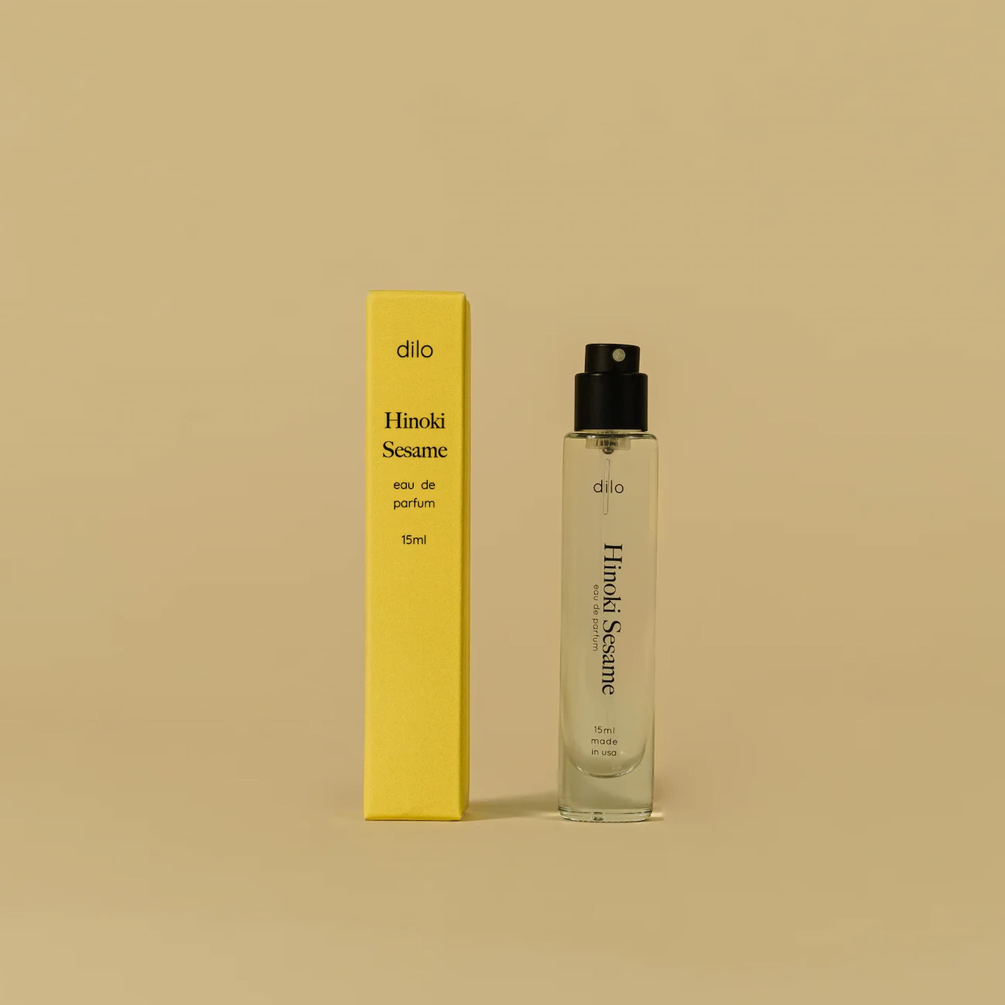 Hinoki Sesame perfume bottle and packaging on a beige background