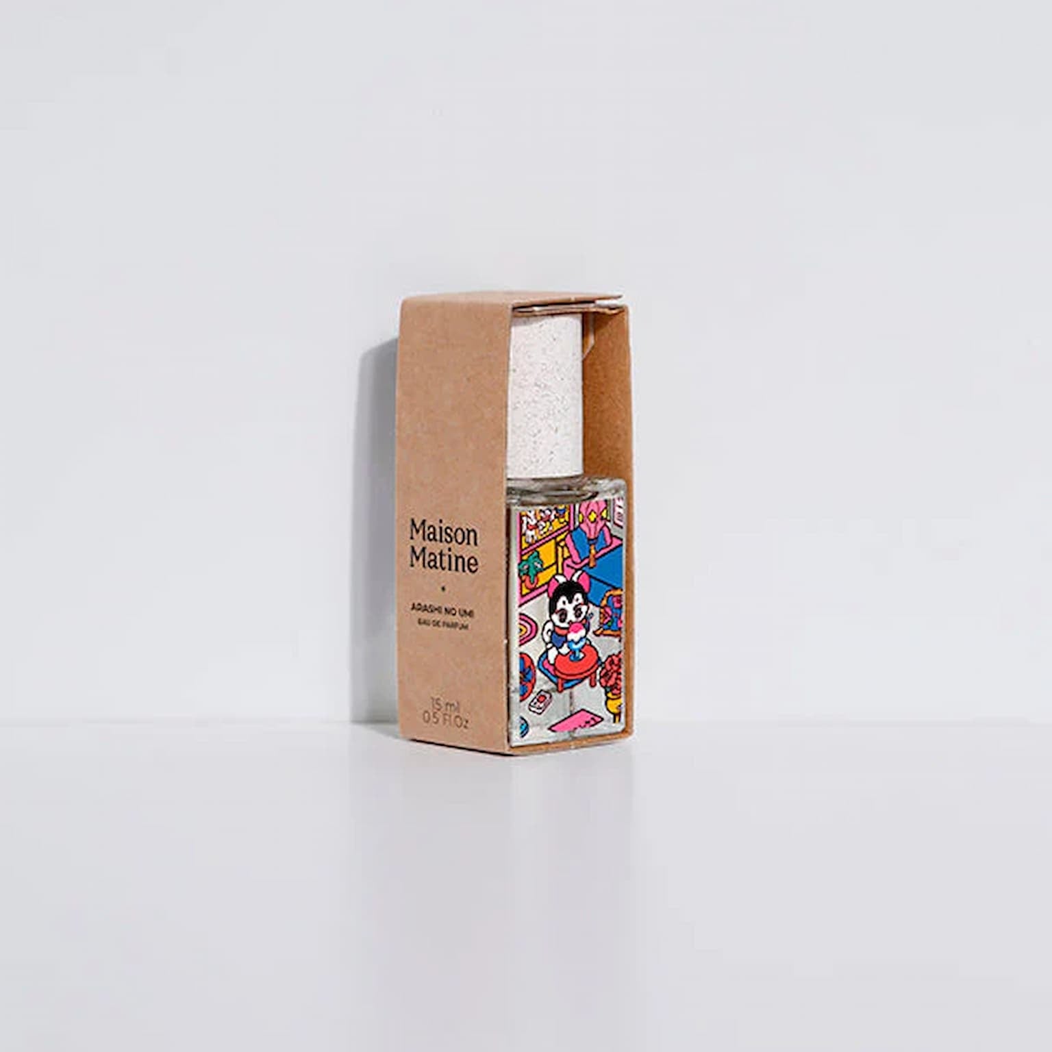 Perfume bottle with colorful label and 'Maison Matine' packaging on a white background