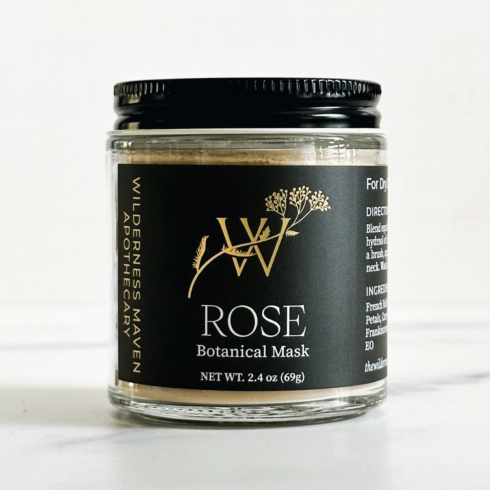 Rose botanical mask jar with black lid on a white background