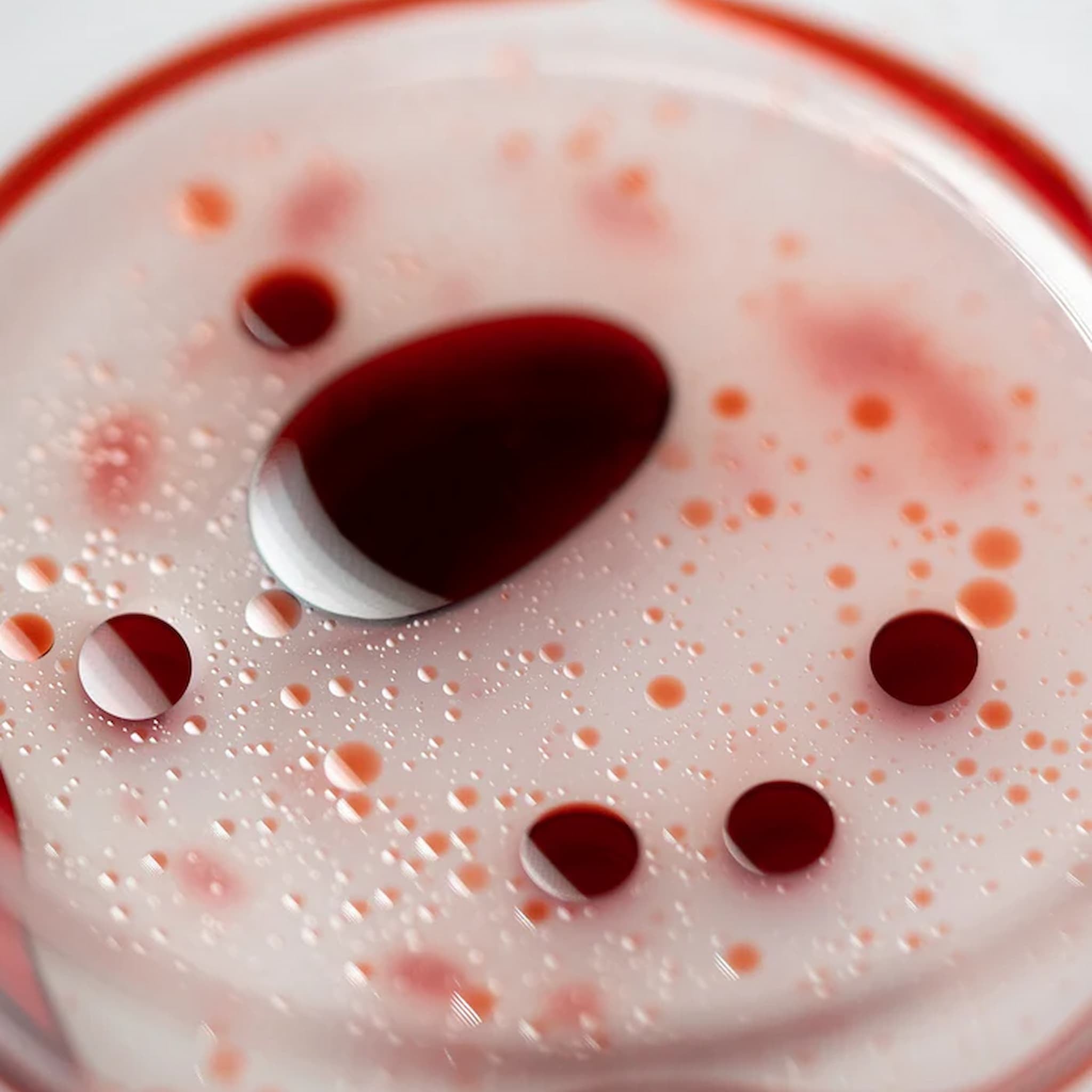Close-up of Rituel de Fille face mist on glass.