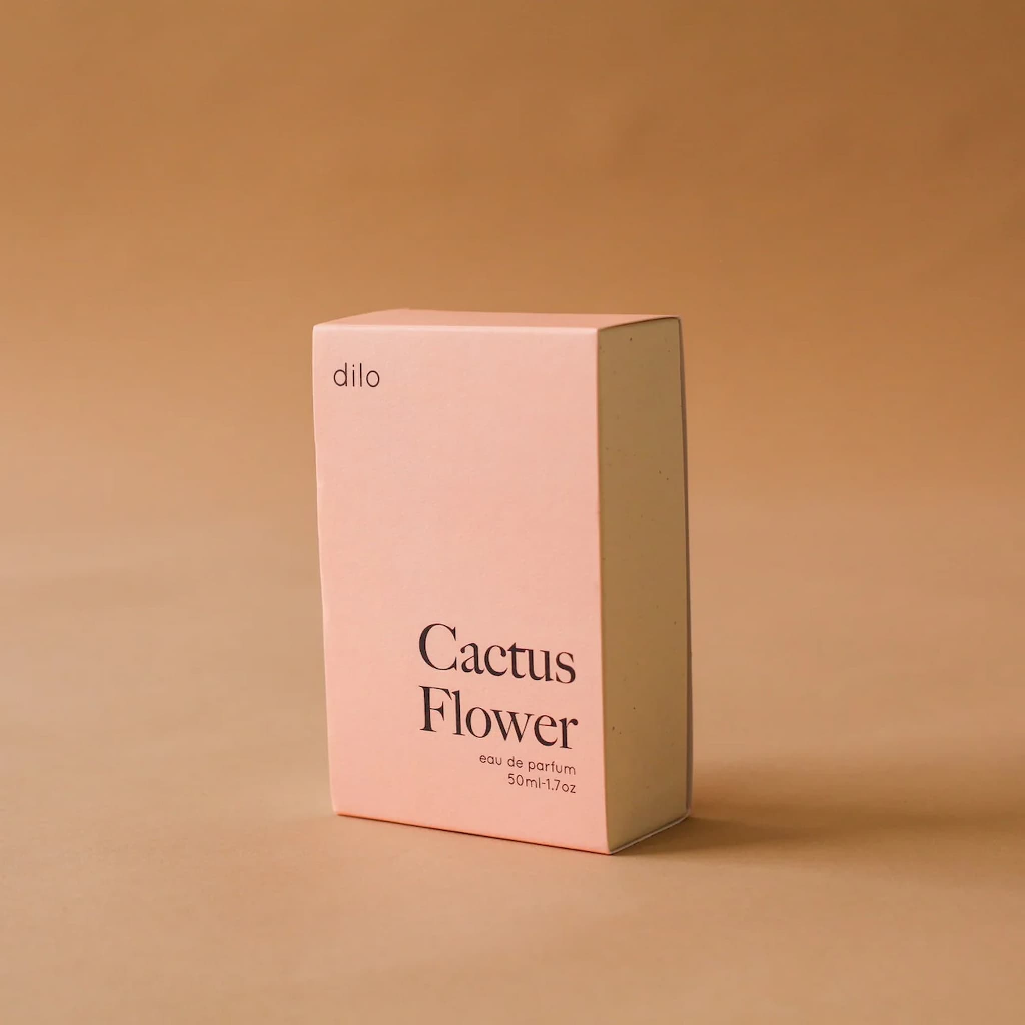 Pink box of 'Cactus Flower' perfume by 'dilo' on a beige background
