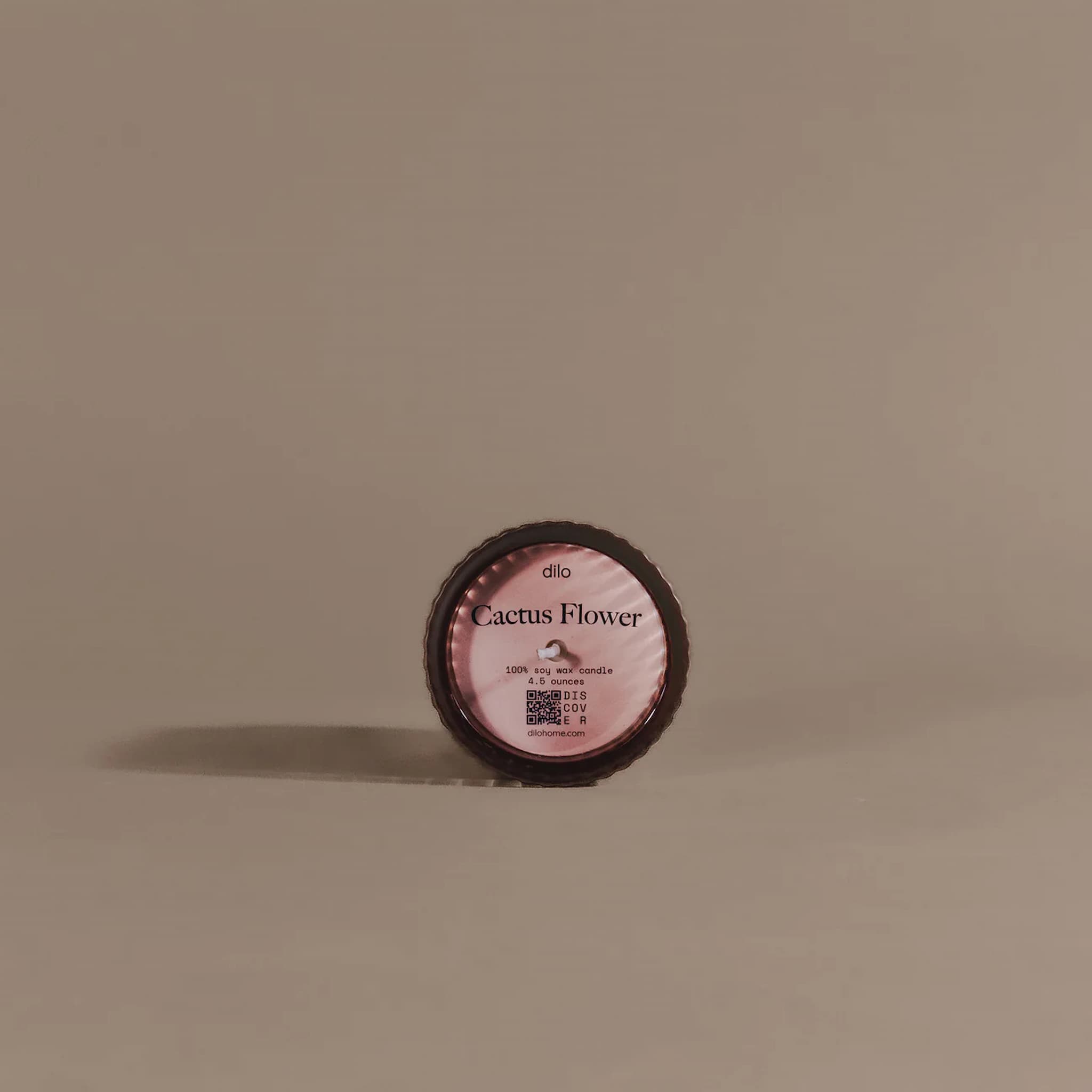 Small round container labeled 'dilo Cactus Flower' on a beige background