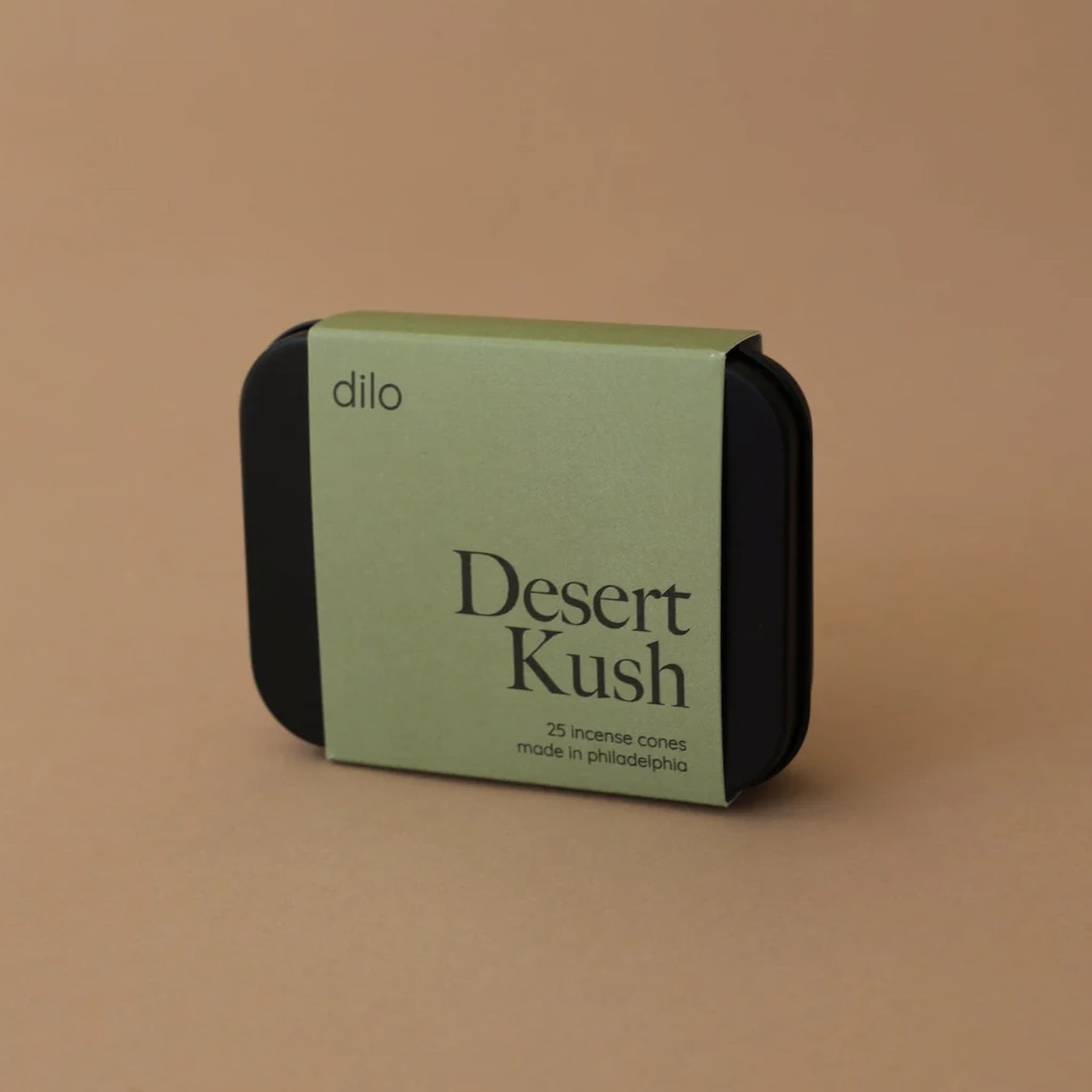 Green and black Desert Kush incense cone packaging with 'dilo' branding on a brown background