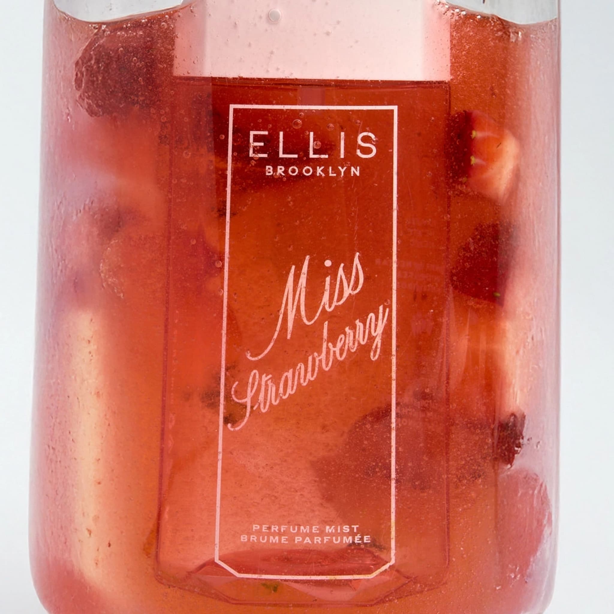 Ellis Brooklyn Miss Strawberry Perfume Mist bottle frozen into a strawberry popsicle.