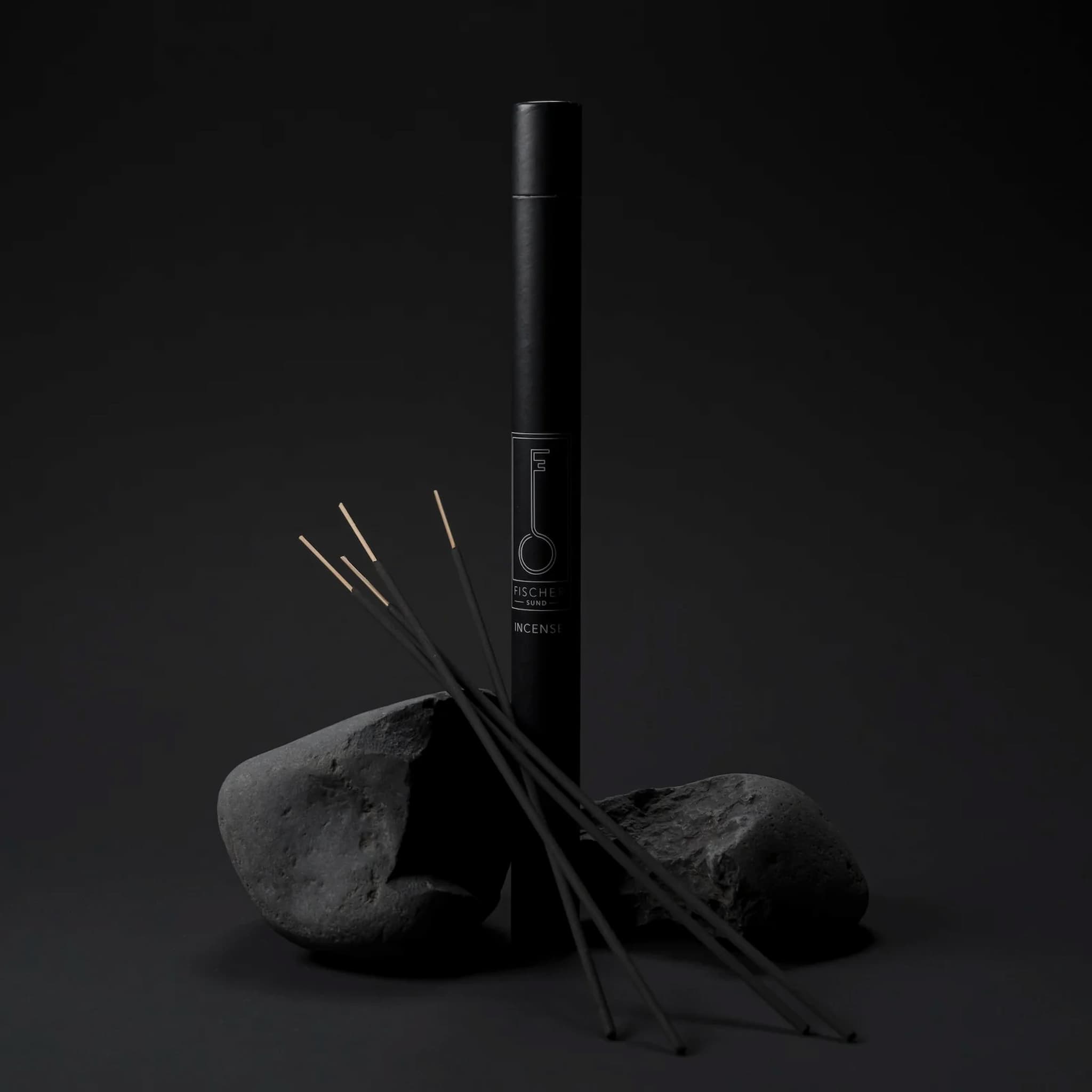 Black incense stick tube by Fischersund with incense sticks on a dark background
