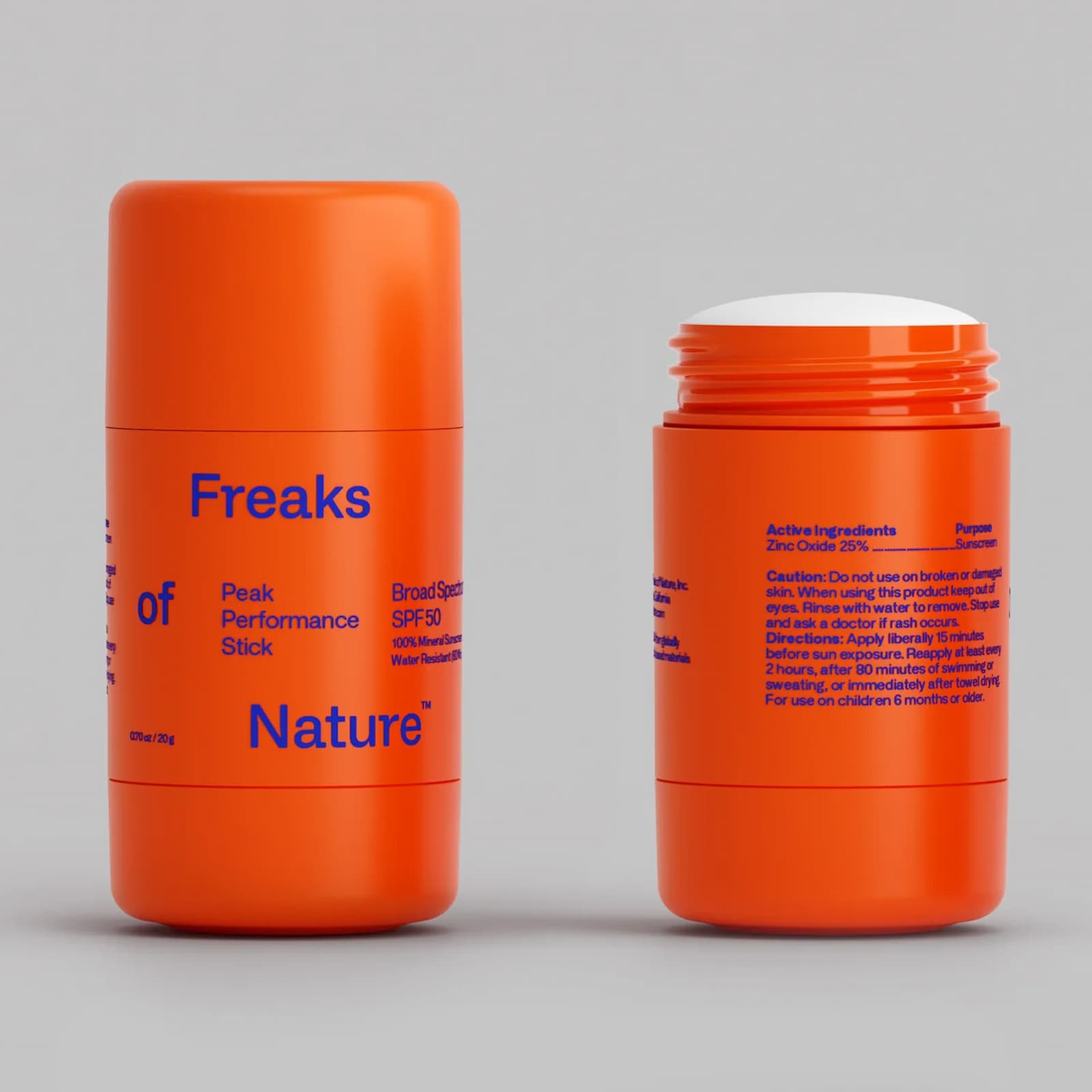 Two bright orange sticks of Freaks of Nature Peak Performance Stick. One is closed, the other is open. Products sit against a white-grey background.