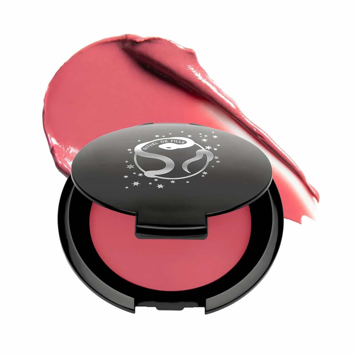 A black makeup compact of Rituel de Fille Inner Glow Pigment Balm in "Bee Sting", with a swatch of product behind it.