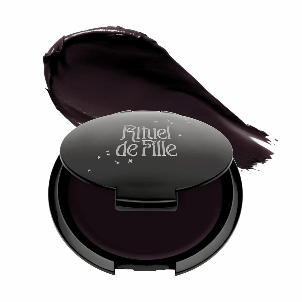 A black compact of Rituel de Fille Inner Glow Creme Pigment in "Eclipse", as well as the product swatch, against a white background.