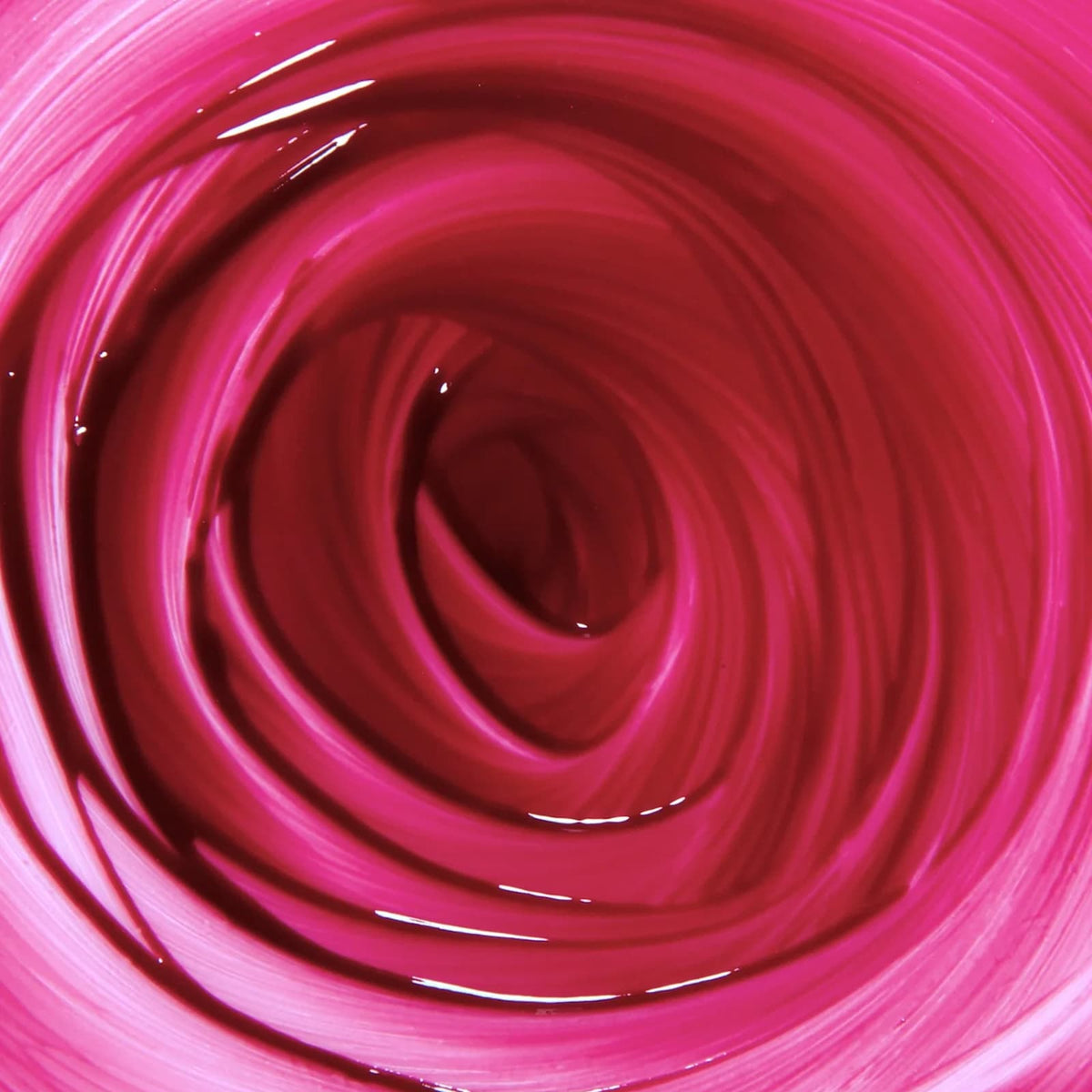 A pinkish-red swirl of Rituel de Fille Inner Glow Pigment Balm in "Glasswing" product.