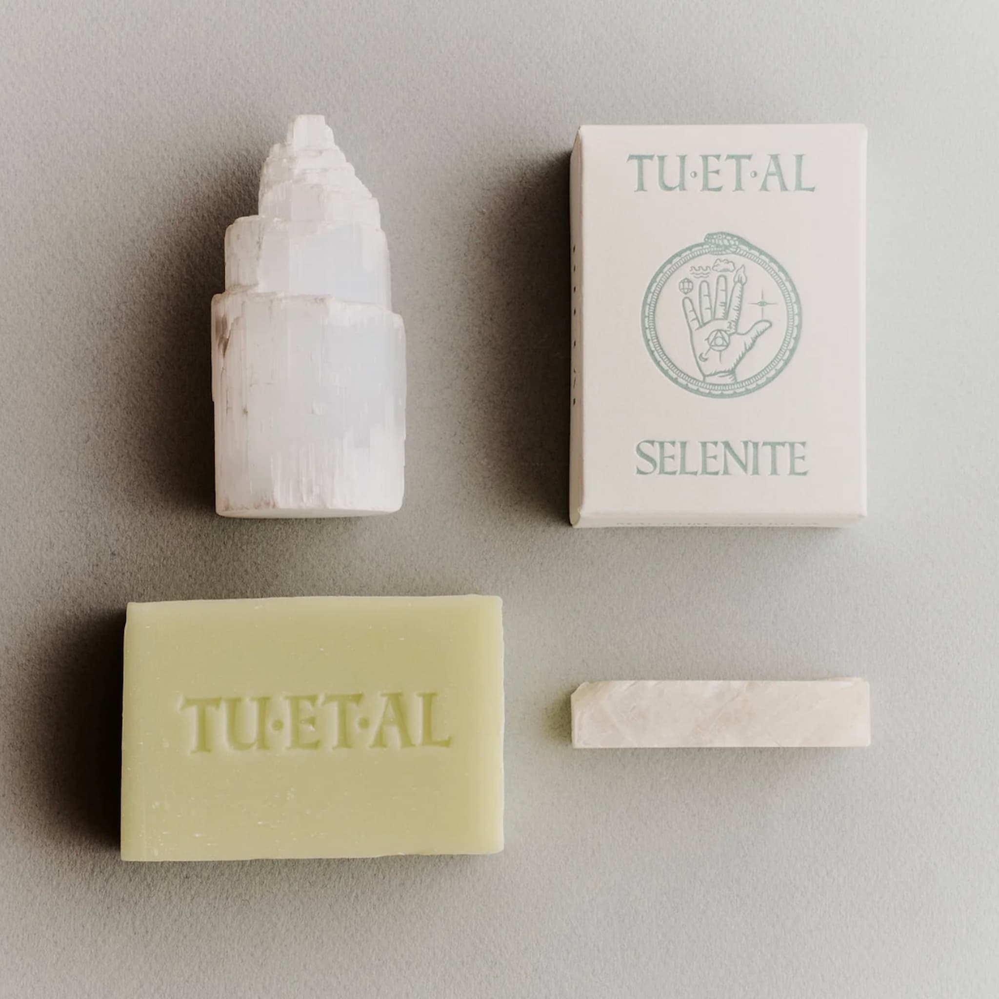 TU ET AL soap bar and box next to crystals on a neutral background