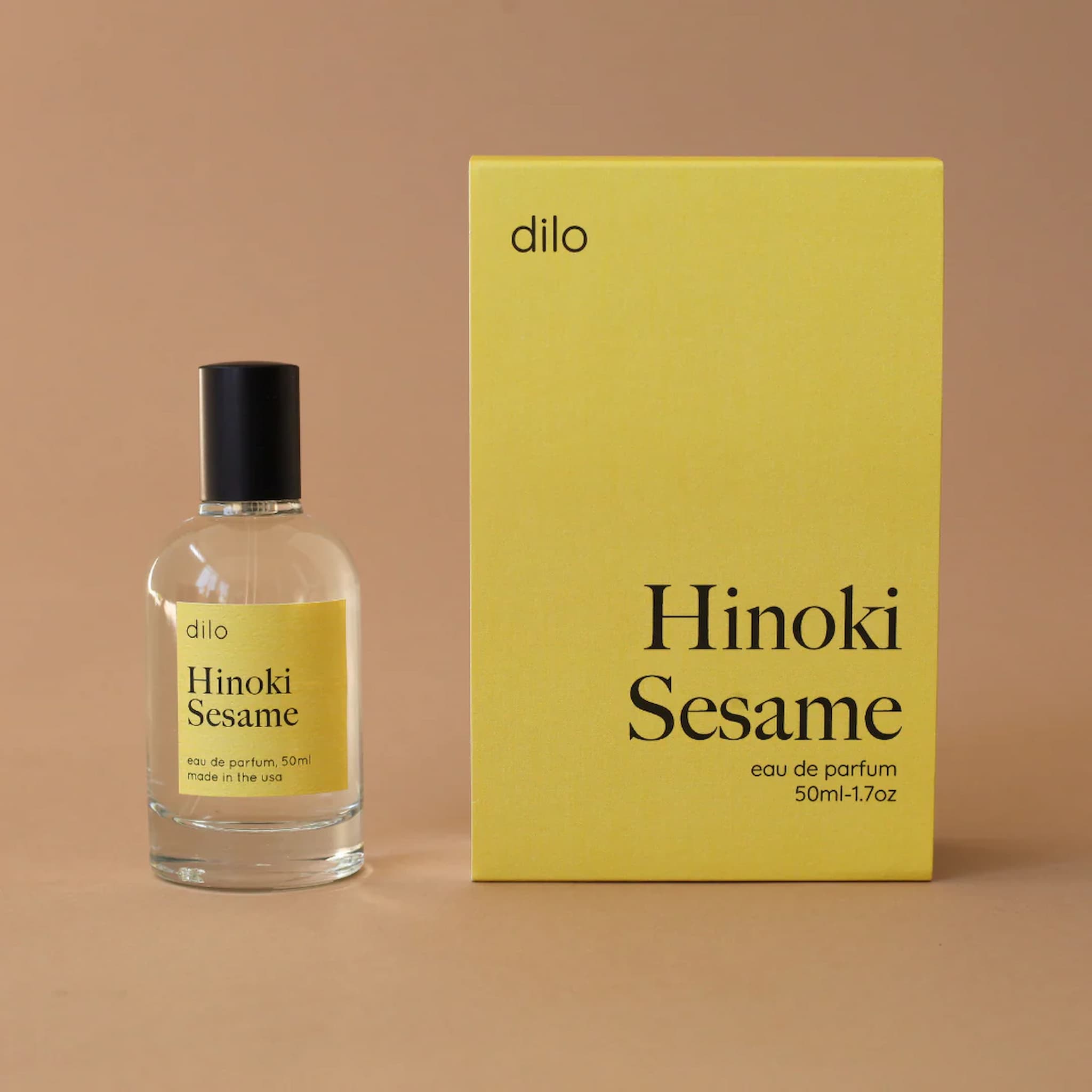 Hinoki Sesame perfume bottle and packaging on a beige background