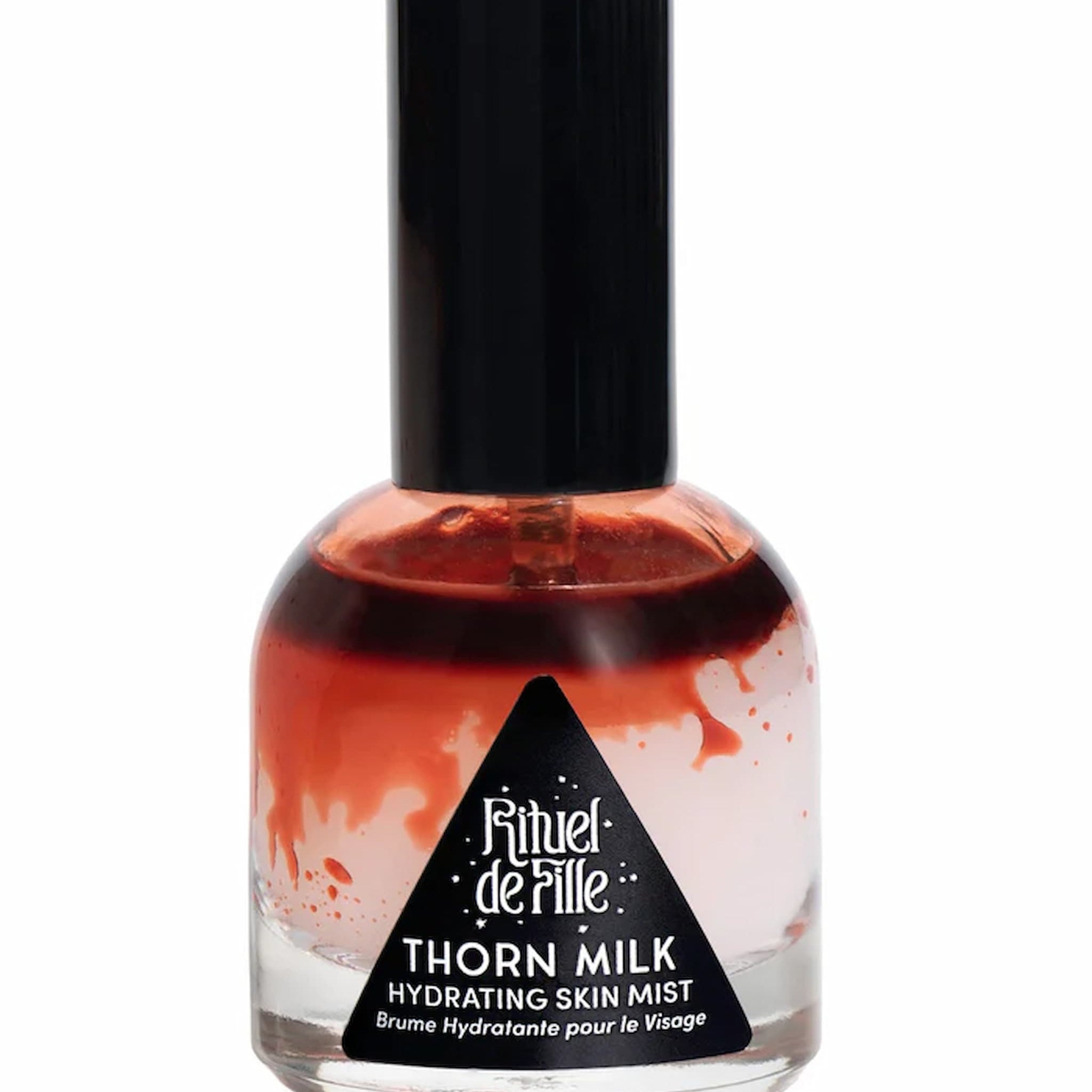 Bottle of Rituel de Fille Thorn Milk Hydrating Skin Mist on a white background