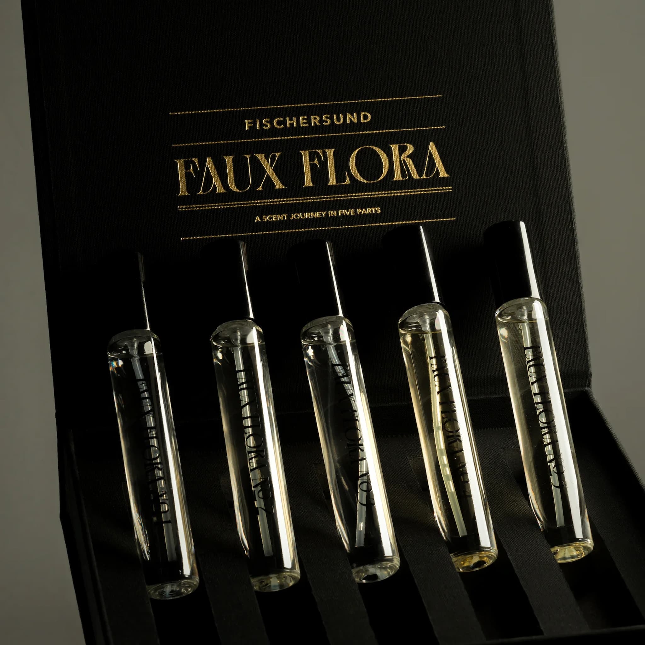 Set of clear vials with labels on a black box labeled 'Fischersund Faux Flora'.