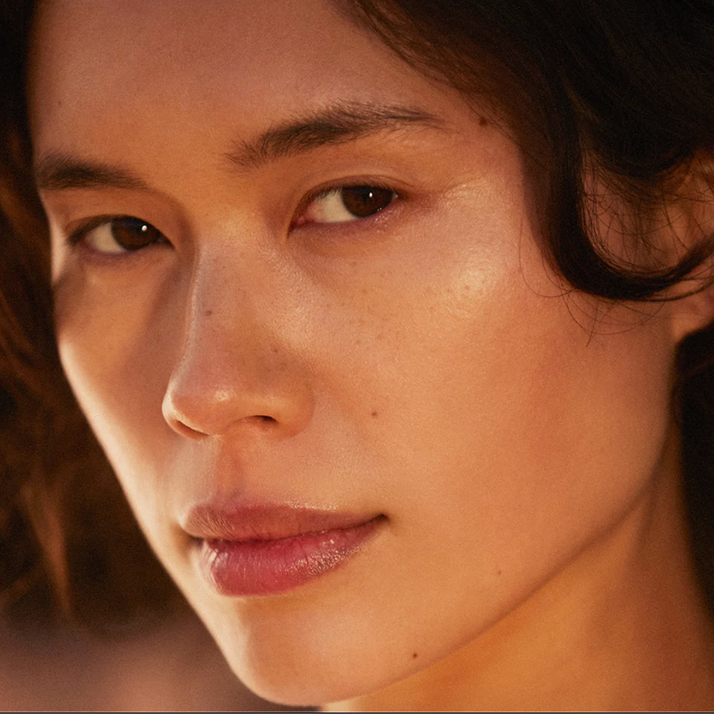Close-up of a person's face with warm lighting