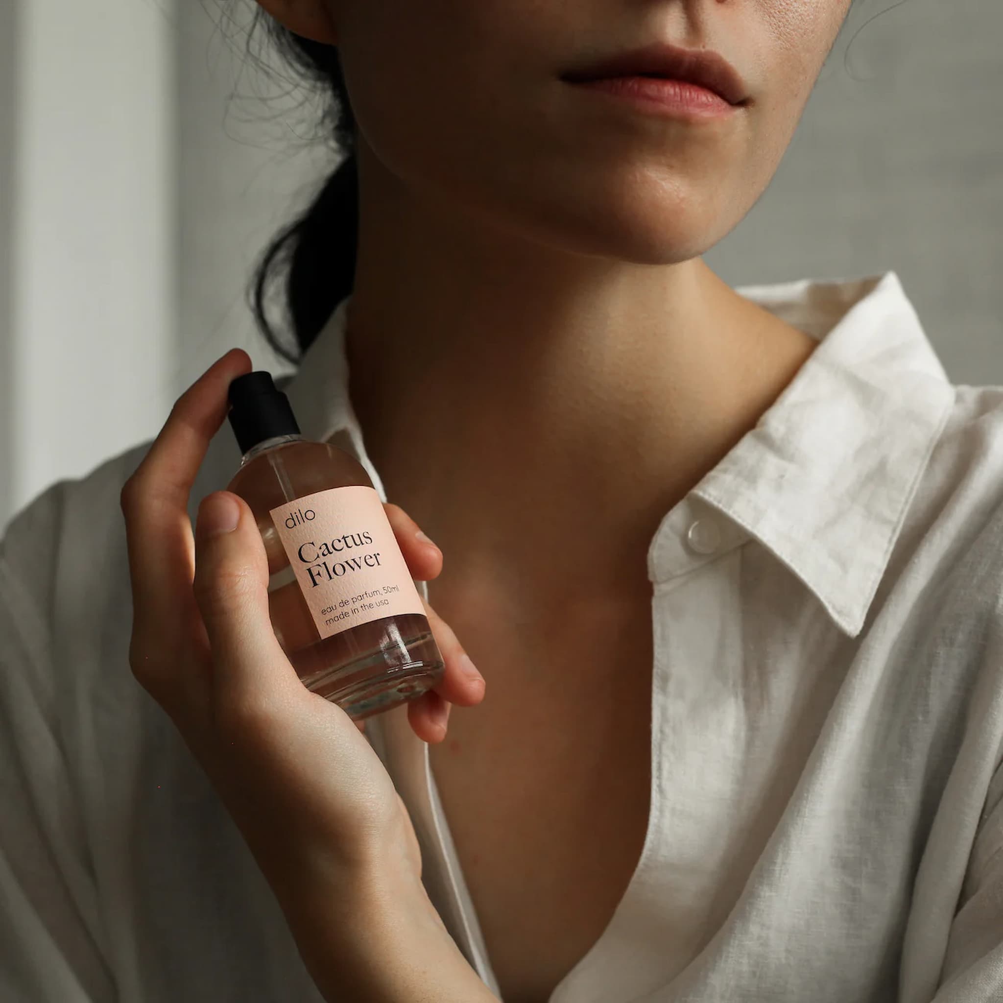 Person holding a bottle of 'Cactus Flower' perfume by dllo