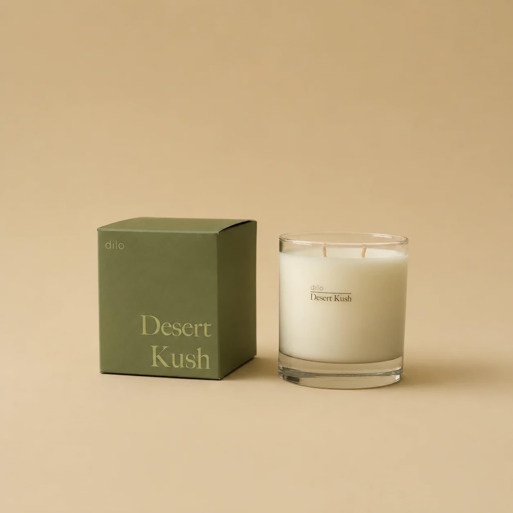 Dilo candle labeled 'Desert Kush' with its packaging on a beige background