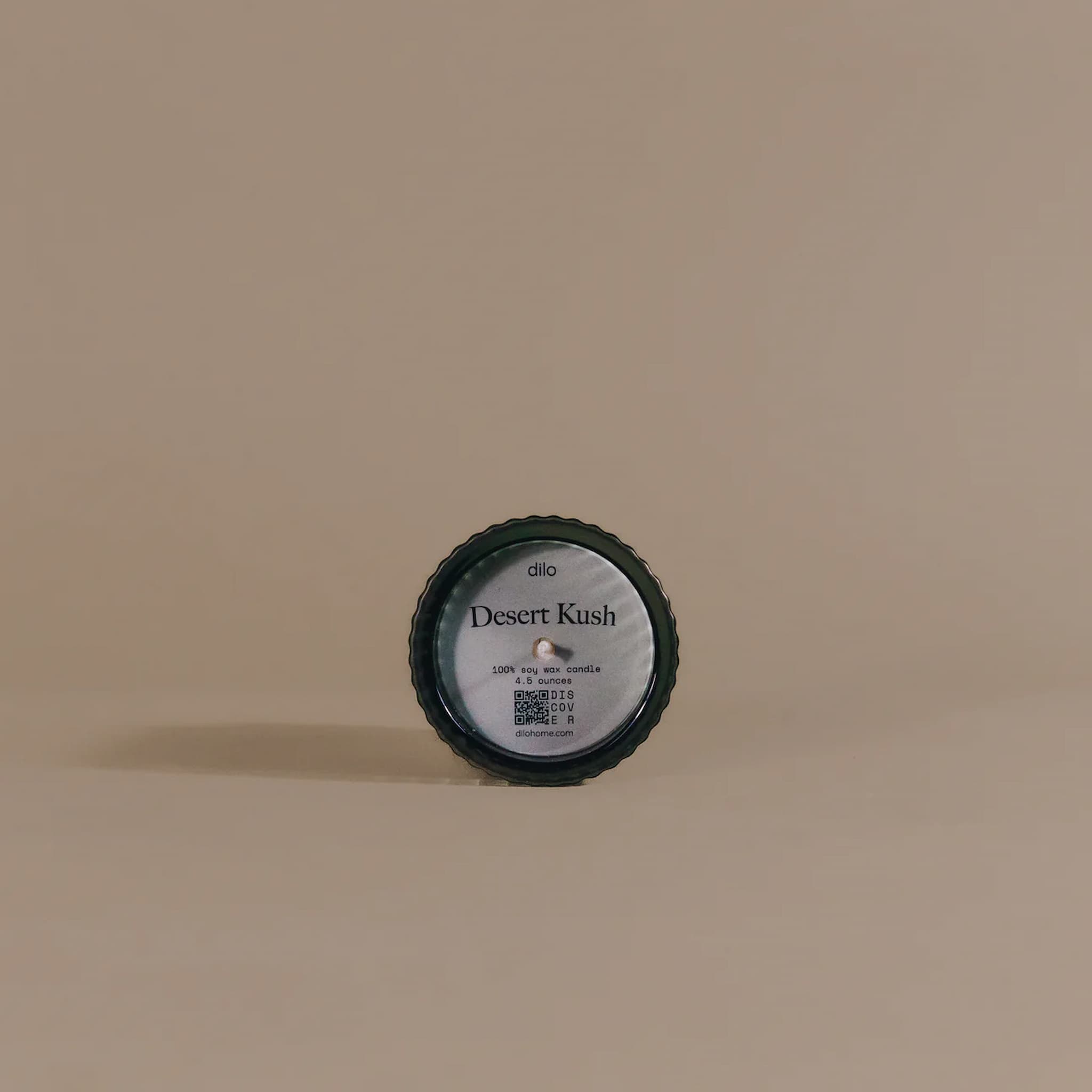 Candle container labeled 'Desert Kush' on a beige background