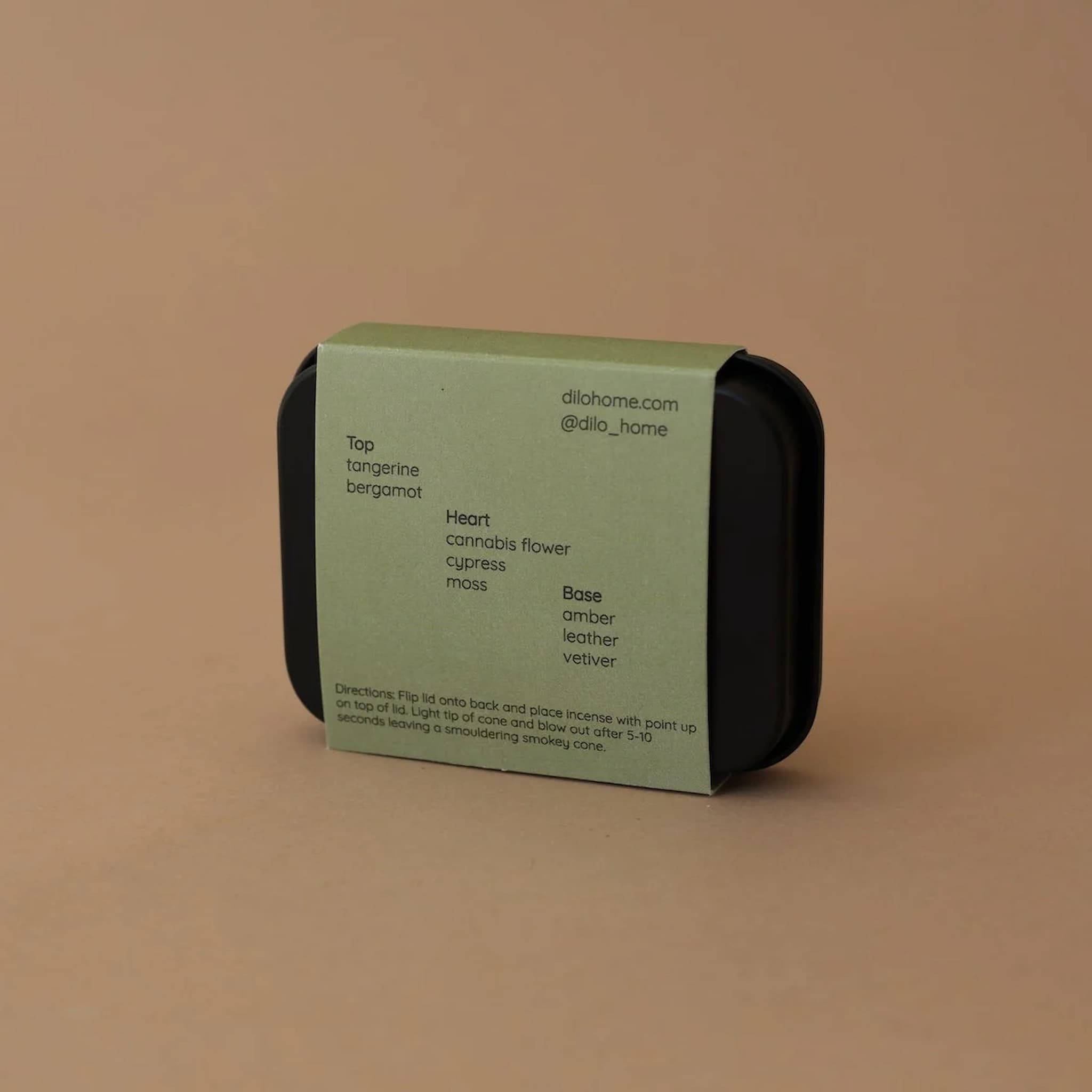 Green and black rectangular product packaging on a brown background