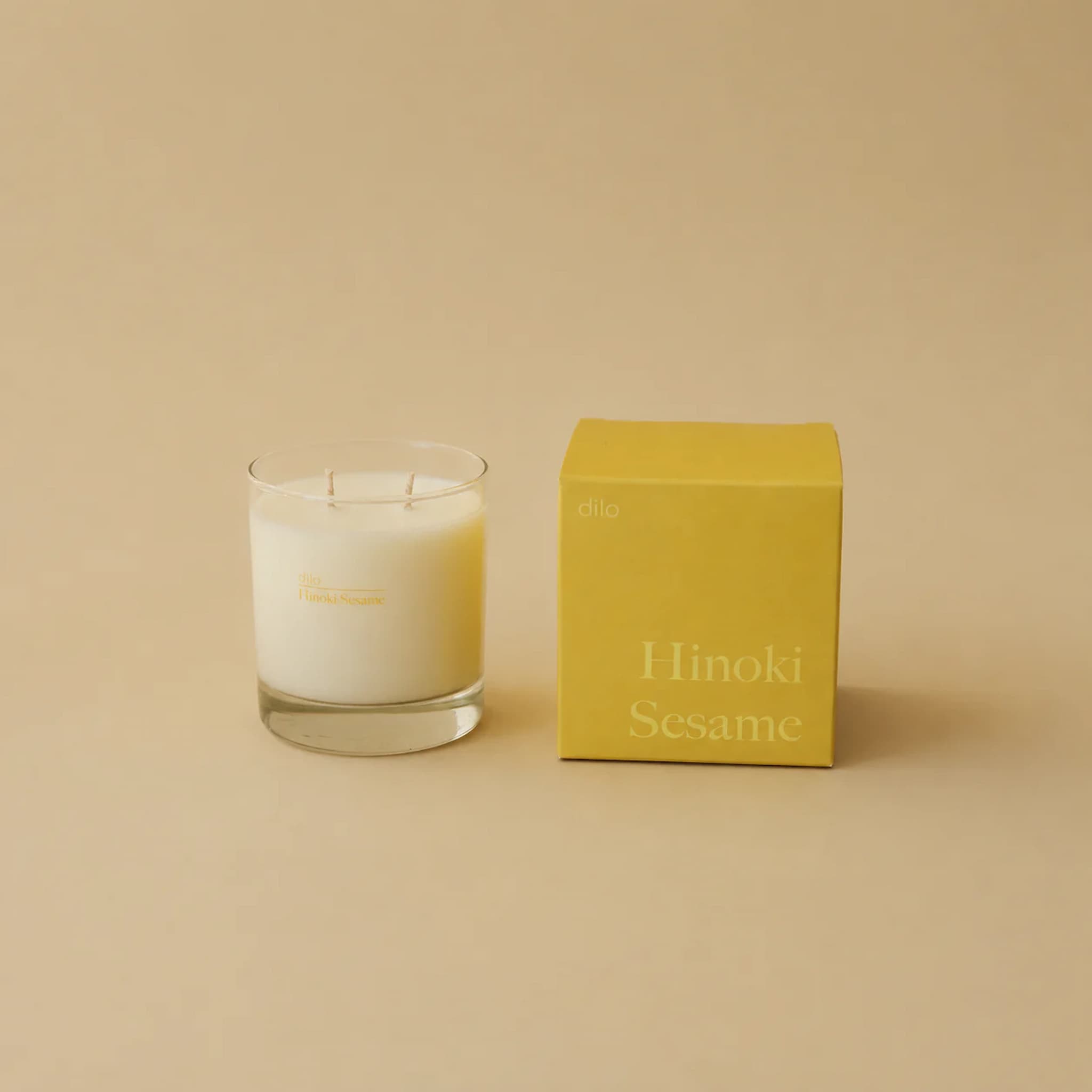 Dilo candle and its packaging labeled 'Hinoki Sesame' on a beige background