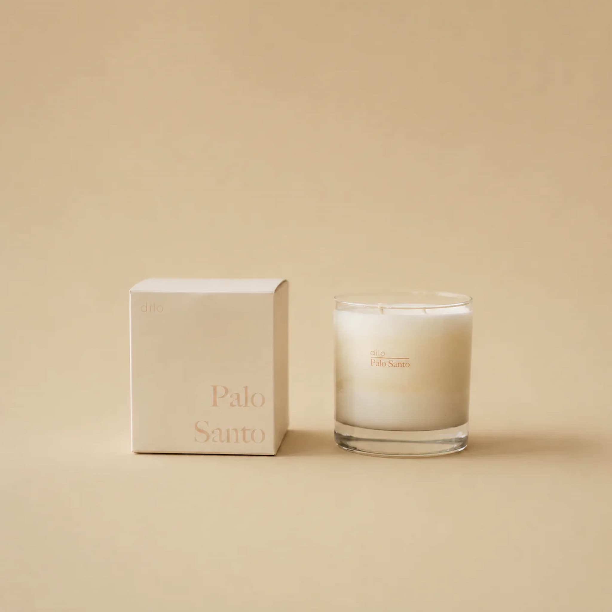 Dilo candle and its packaging labeled 'Palo Santo' on a beige background