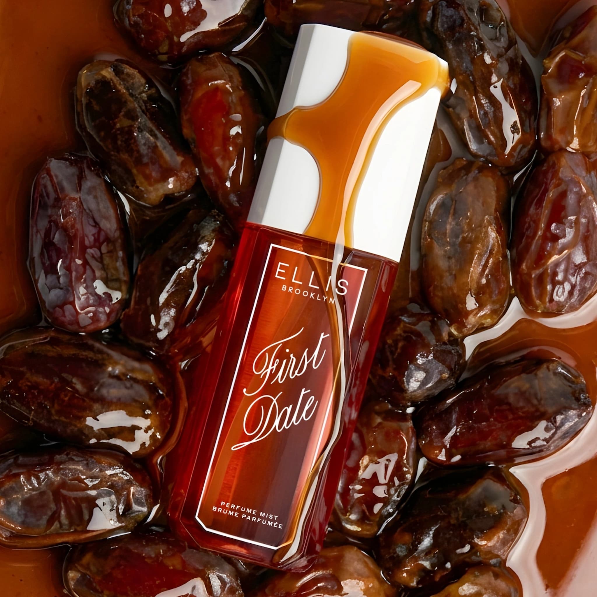 Ellis Brooklyn First Date Perfume Mist on a background of dates in syrup.