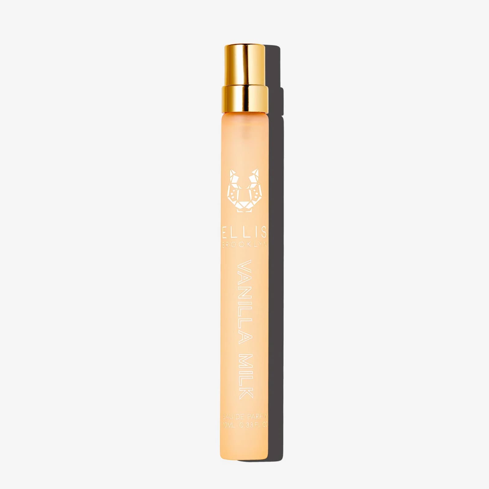 A tall, slim travel-sized bottle of Ellis Brooklyn Vanilla Milk against a white background.