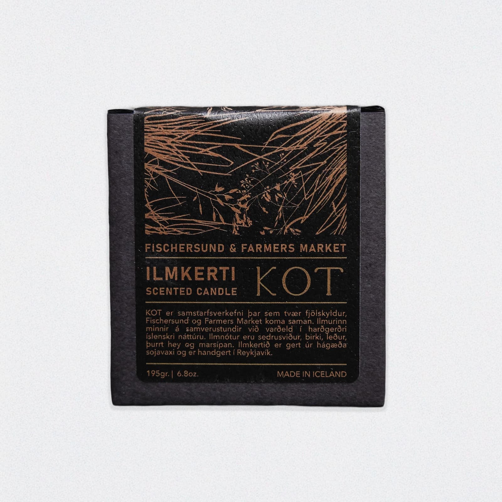 A square black box holding the KOT Scented Candle from Fischersund & Farmers Market. The box features a metallic illustration on the front, set against a white background.