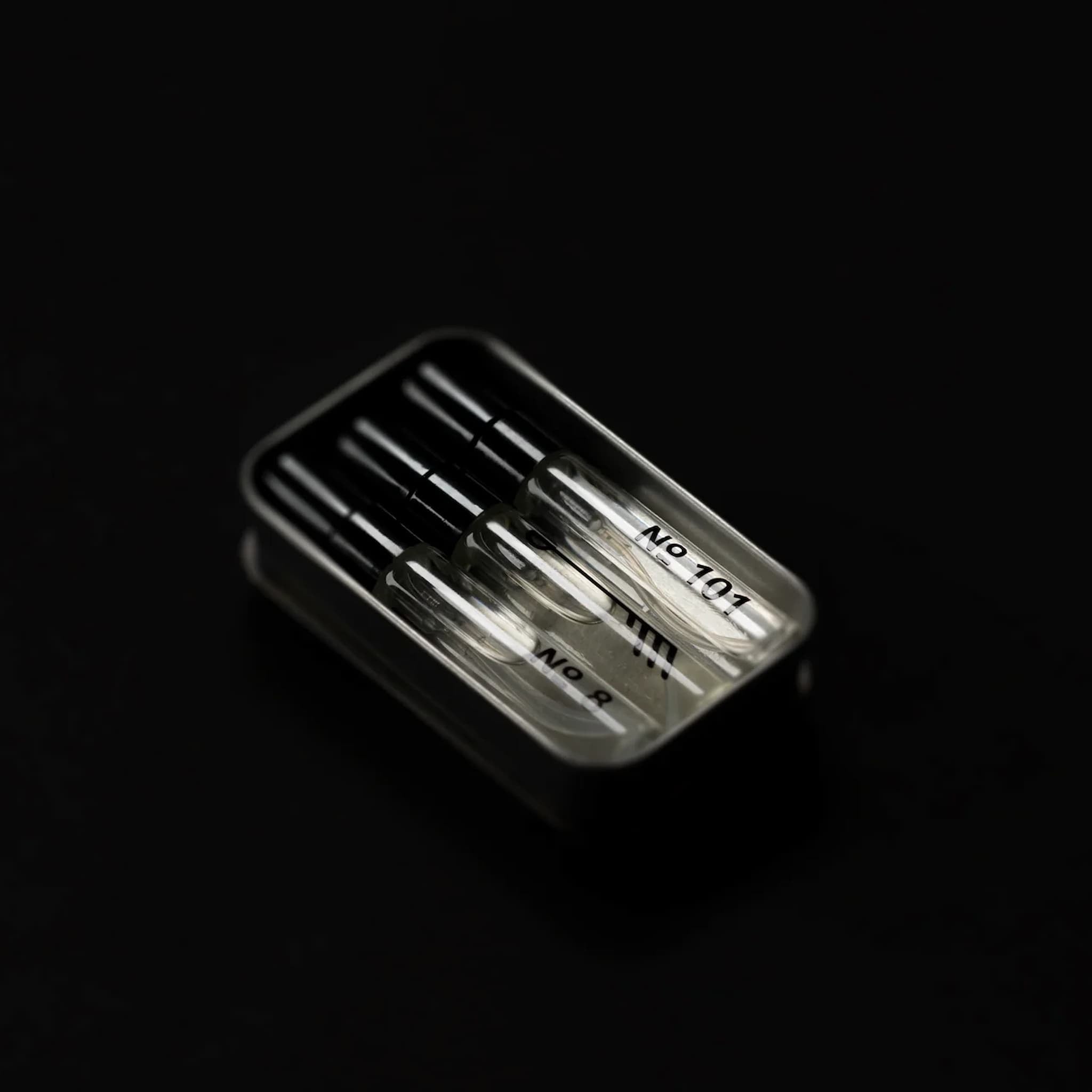 Set of three Fischersund fragrance vials in a tin on a black background