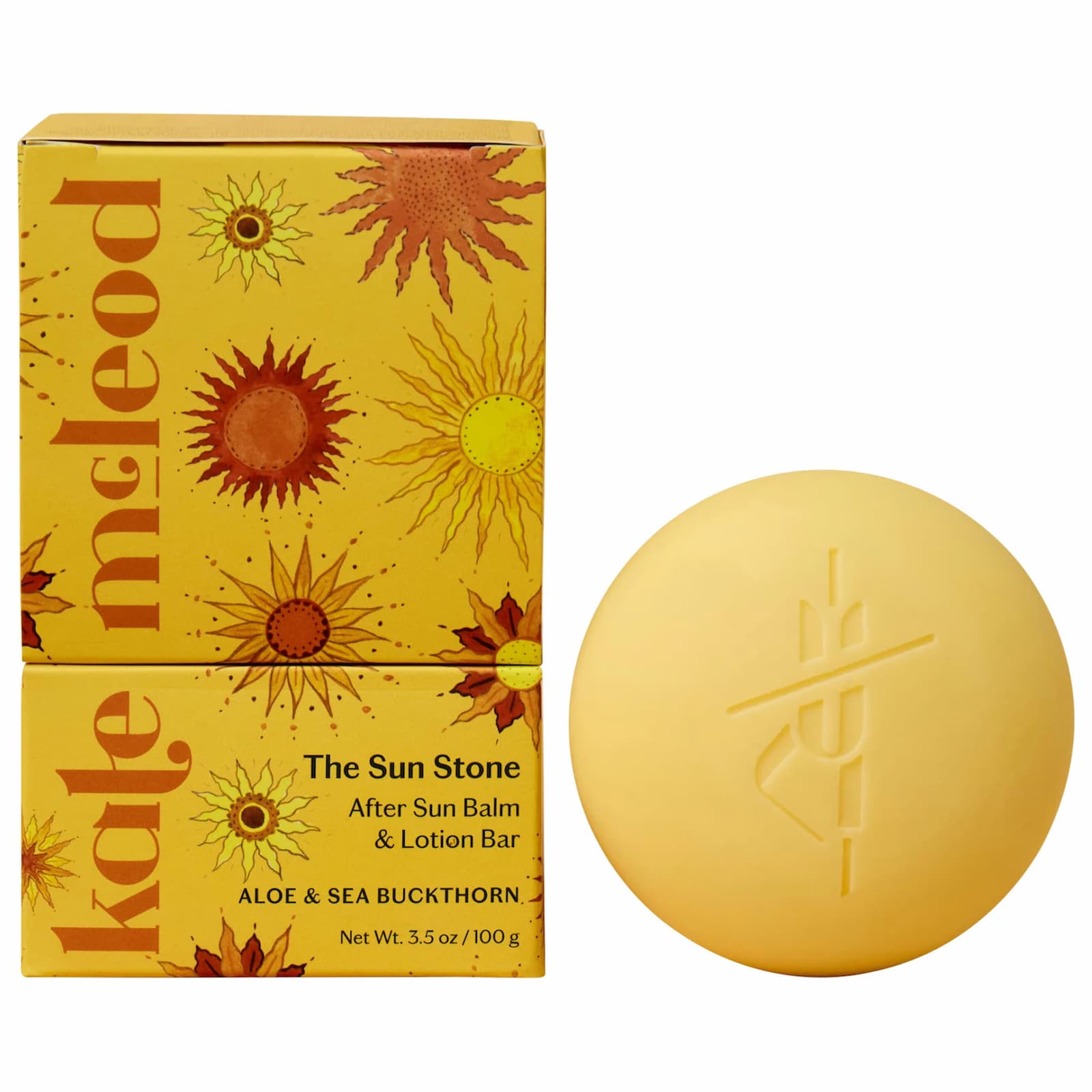 A round yellow Kate McLeod Sun Stone next to two orange and yellow packaging boxes against a white background.