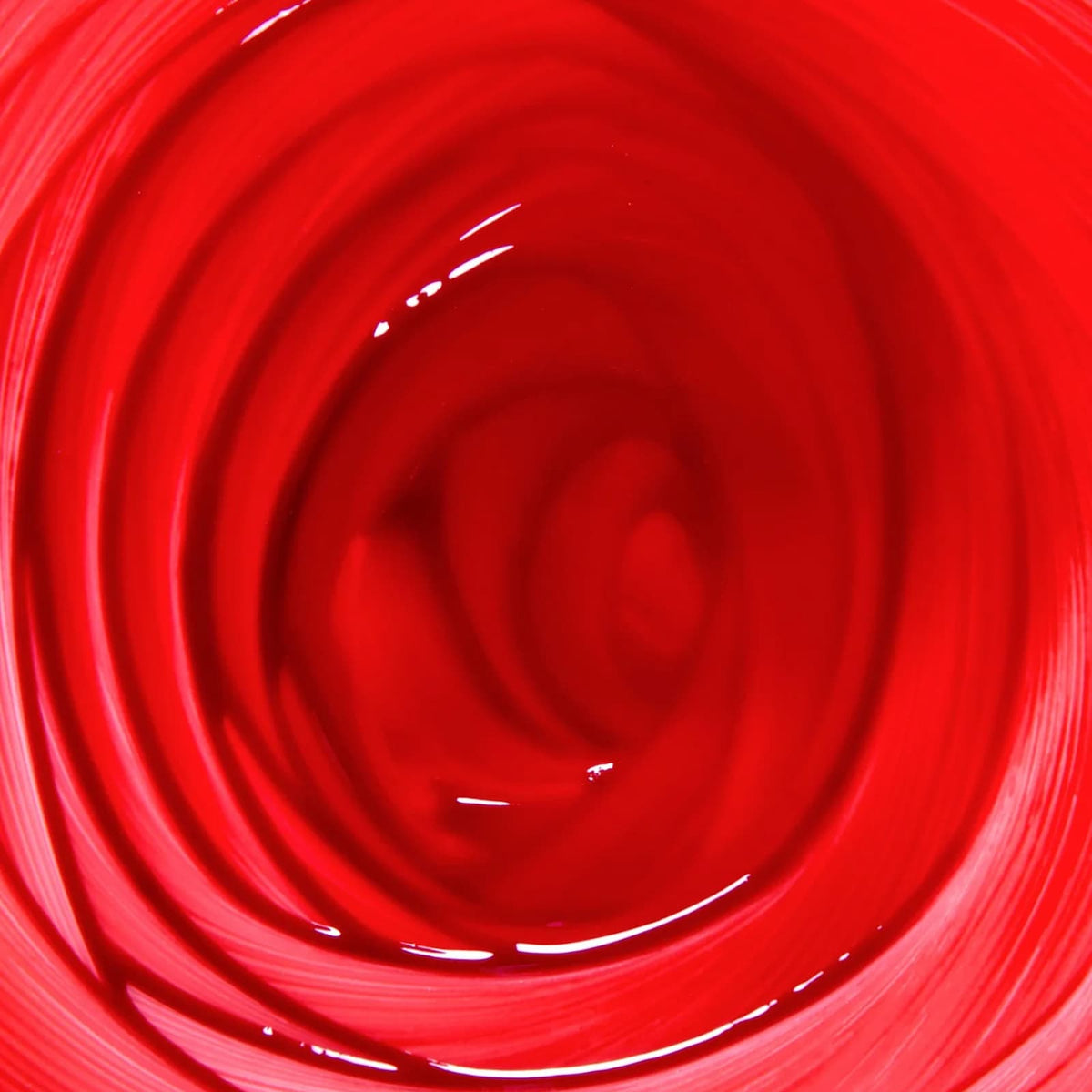 A close-up swirl of Rituel de Fille Inner Glow Pigment Balm in "Bloodflower".