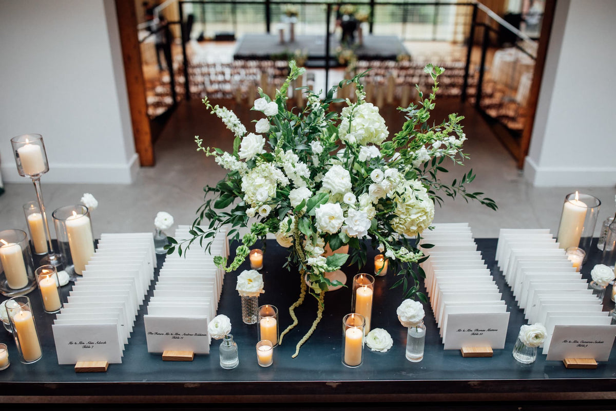 A Roundhouse wedding table featuring white and green flowers by Witch Hazel in Beacon, NY.