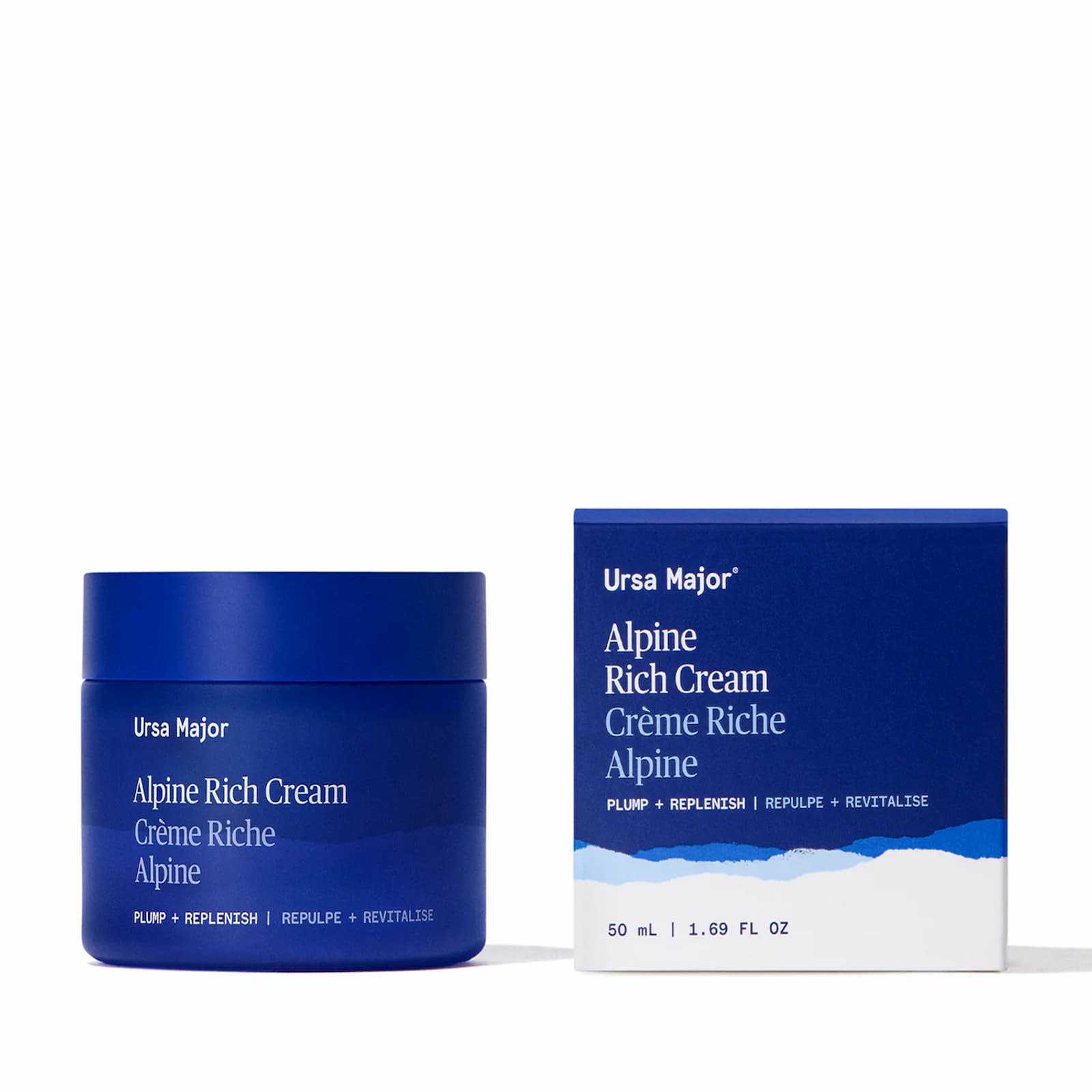 A dark blue jar of Ursa Major Alpine Rich Cream and its blue and white packaging box against a white background.